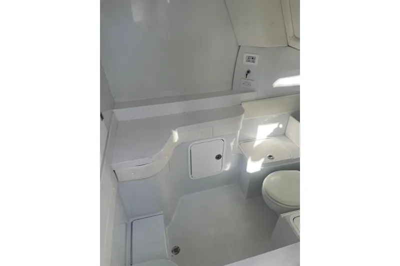 Slide: The Image of 2023 Conch 41 Center Console boat interior with modern white bathroom amenities. - 13