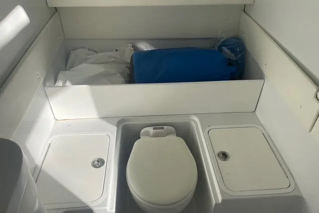 Slide: The Image of 2023 Conch 41 Center Console boat interior with storage and toilet. - 14