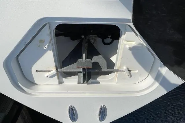 Slide: The Image of Anchor compartment of 2023 Conch 41 Center Console boat, featuring a neatly stored anchor. - 18