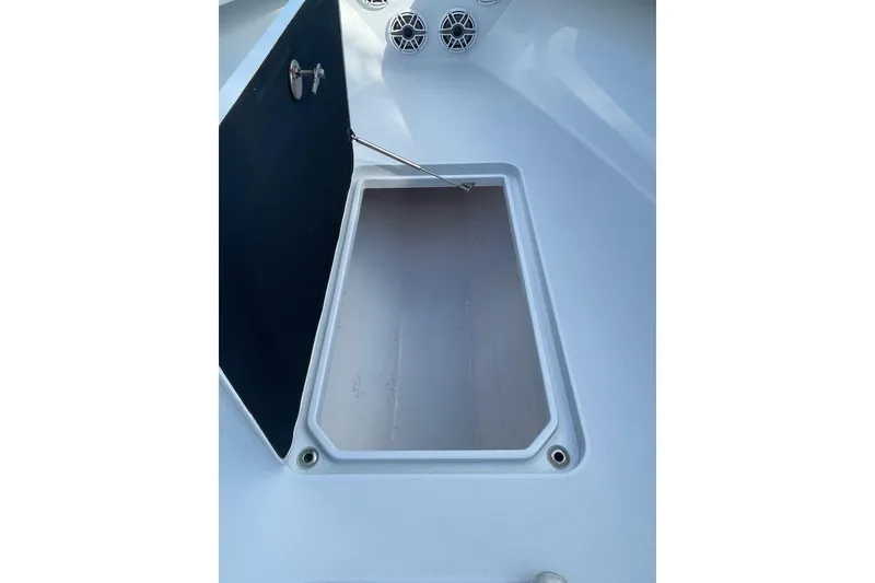 Slide: The Image of 2023 Conch 41 Center Console storage compartment with open hatch and speakers. - 19