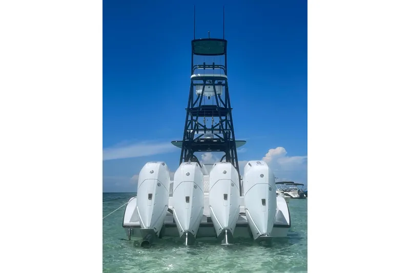 Slide: The Image of 2023 Conch 41 Center Console with four outboard engines in clear water. - 2