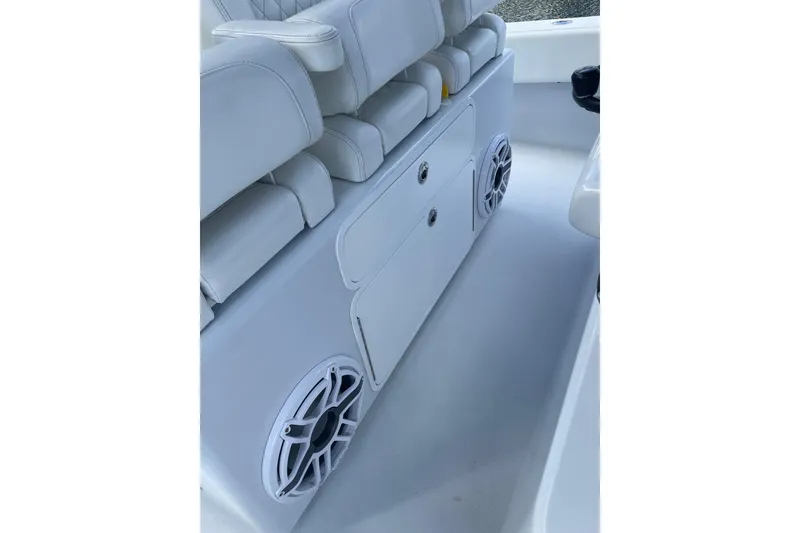 Slide: The Image of 2023 Conch 41 Center Console interior with white seating and built-in speakers. - 21