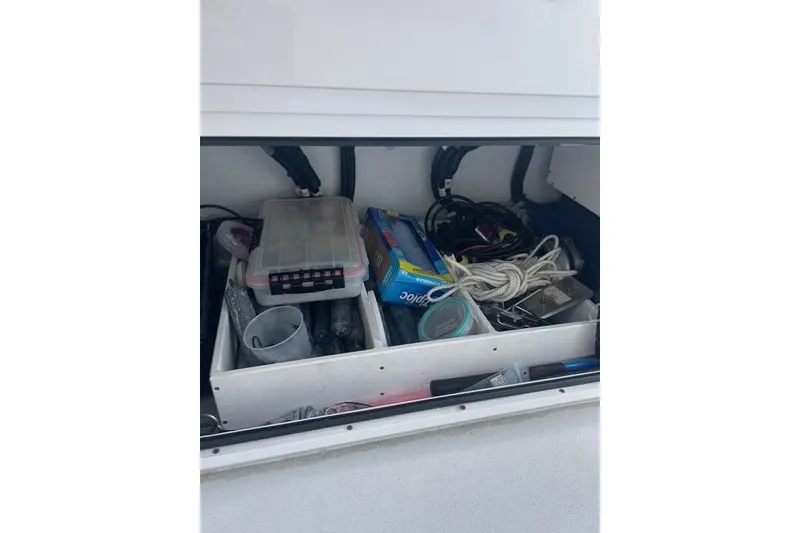 Slide: The Image of Storage compartment of 2023 Conch 41 Center Console with various boating supplies. - 23