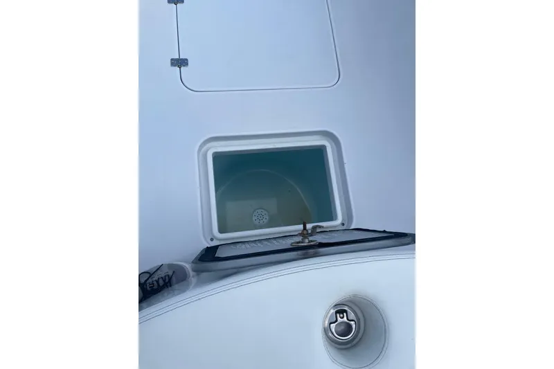 Slide: The Image of 2023 Conch 41 Center Console boat compartment with hatch and latch detail. - 26