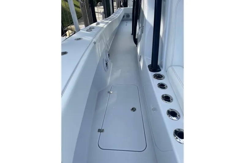 Slide: The Image of 2023 Conch 41 Center Console boat interior with rod holders and storage compartments. - 28