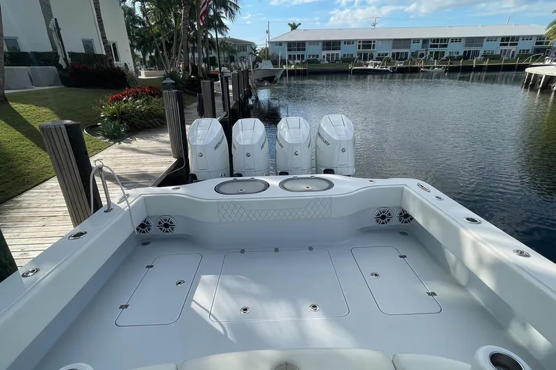 Slide: The Image of 2023 Conch 41 Center Console boat docked, featuring spacious deck and powerful engines. - 31