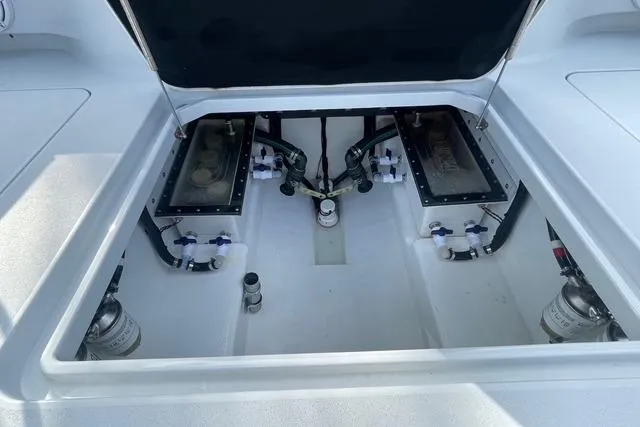 Slide: The Image of 2023 Conch 41 Center Console boat engine compartment with open hatch, showcasing internal components. - 32