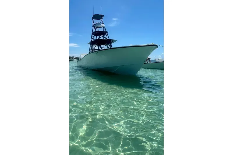 Slide: The Image of 2023 Conch 41 Center Console boat in clear turquoise water under blue sky. - 39