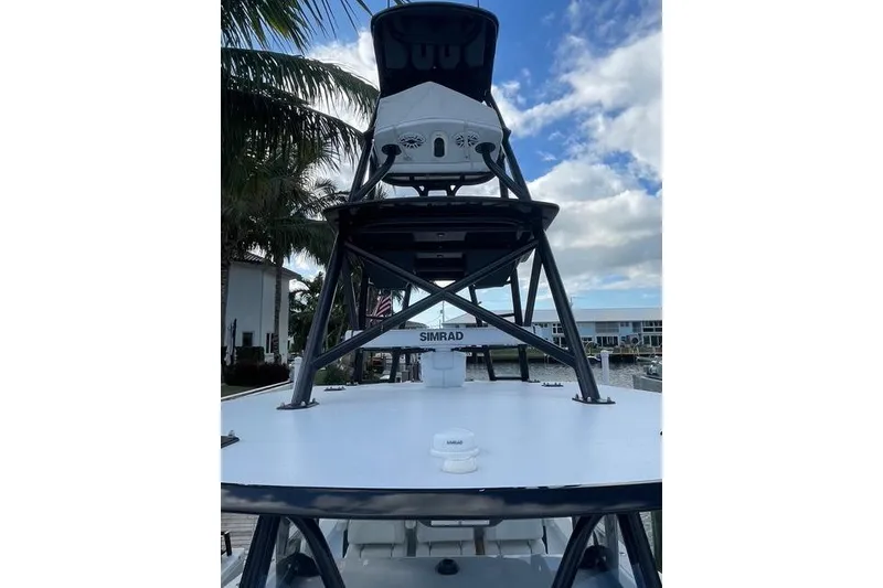 Slide: The Image of 2023 Conch 41 Center Console boat with Simrad equipment, docked under a partly cloudy sky. - 5