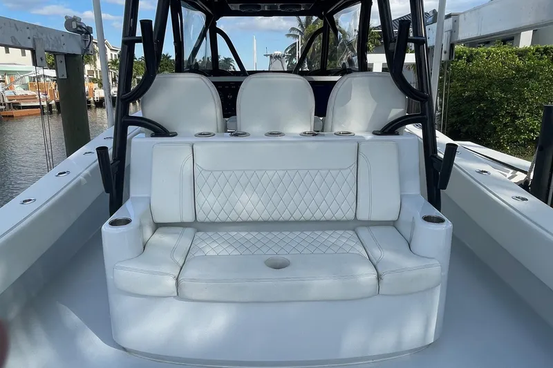 Slide: The Image of 2023 Conch 41 Center Console boat with white seating and cup holders. - 8