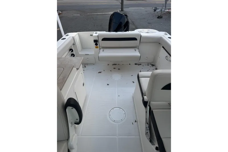 Slide: The Image of 2021 Sailfish 245DC boat interior with seating and clean deck. - 11