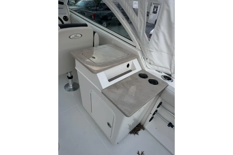 Slide: The Image of 2021 Sailfish 245DC boat interior with sink and cup holders. - 13