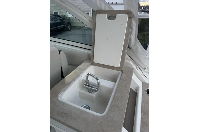 Slide: The Image of Sailfish 245DC 2021 boat sink with faucet and countertop. - 14