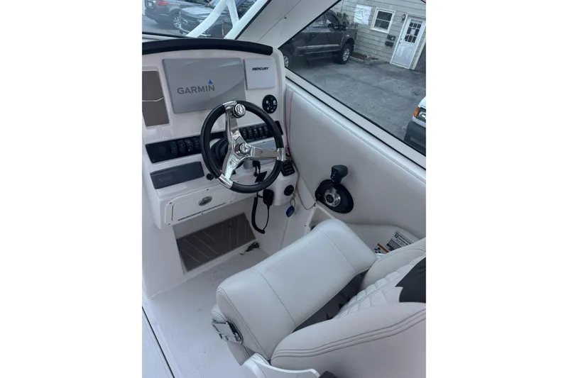 Slide: The Image of 2021 Sailfish 245DC boat cockpit with Garmin navigation and Mercury controls. - 25