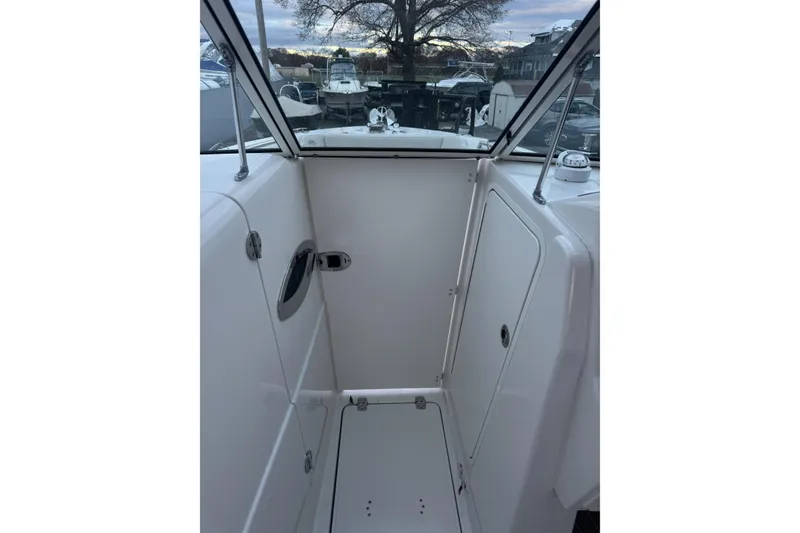 Slide: The Image of 2021 Sailfish 245DC boat interior with white cabin and clear windows. - 28