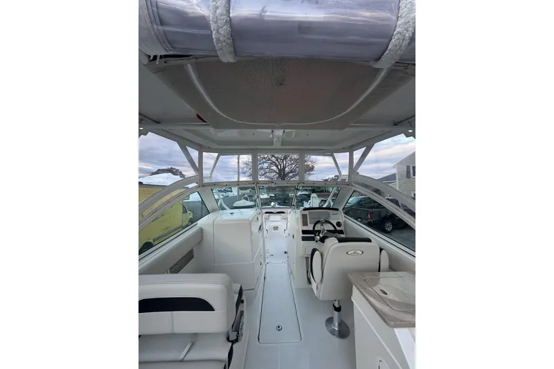 Slide: The Image of 2021 Sailfish 245DC boat interior with seating and steering console. - 9