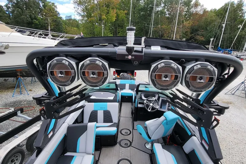 Slide: The Image of 2022 MasterCraft X24 boat interior with premium speakers and modern seating. - 12