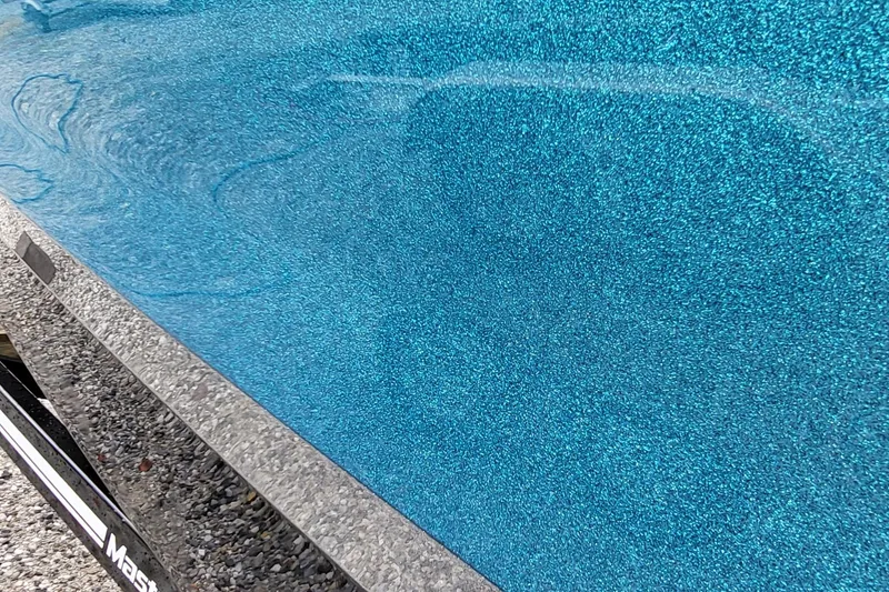 Slide: The Image of 2022 MasterCraft X24 boat with shimmering blue metallic finish. - 16