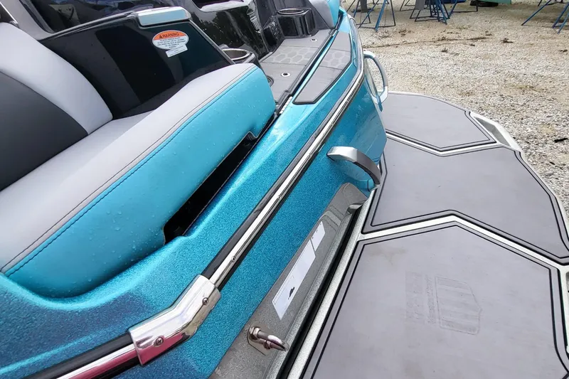 Slide: The Image of 2022 MasterCraft X24 boat with sleek blue design and modern seating. - 17