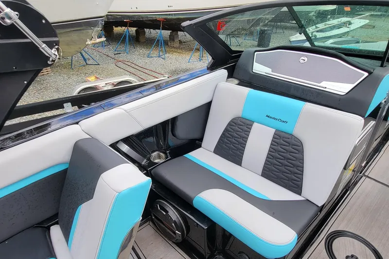 Slide: The Image of 2022 MasterCraft X24 boat interior with stylish blue and gray seating. - 7