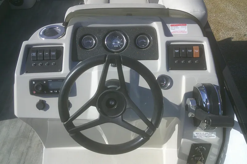 Slide: The Image of Steering console of 2021 Crest Classic LX 220 SLC boat with controls and gauges. - 10