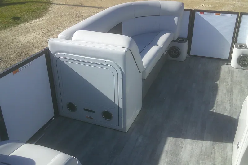 Slide: The Image of 2021 Crest Classic LX 220 SLC pontoon boat interior with gray seating and flooring. - 11
