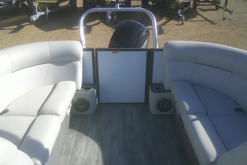 Slide: The Image of 2021 Crest Classic LX 220 SLC pontoon boat interior with gray seating and speakers. - 14