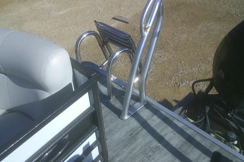 Slide: The Image of 2021 Crest Classic LX 220 SLC boat with ladder and seating, parked on gravel. - 15