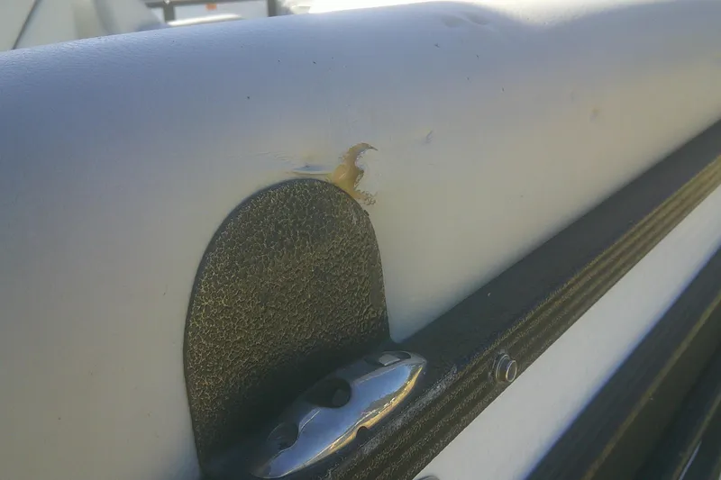 Slide: The Image of Damaged upholstery on 2021 Crest Classic LX 220 SLC boat, showing a tear and wear. - 16
