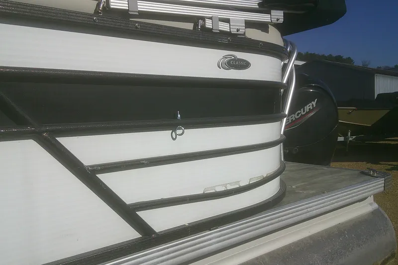 Slide: The Image of 2021 Crest Classic LX 220 SLC pontoon boat with Mercury engine, docked outdoors. - 18