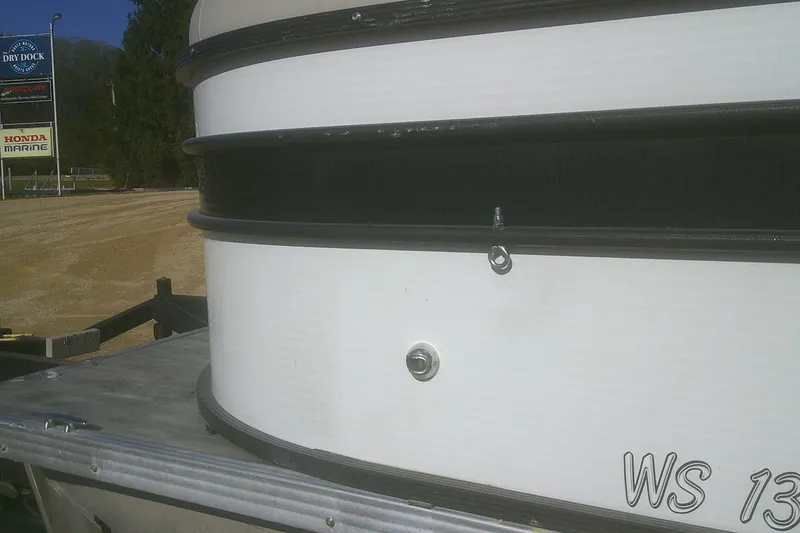 Slide: The Image of 2021 Crest Classic LX 220 SLC pontoon boat on trailer, near Honda Marine sign. - 19