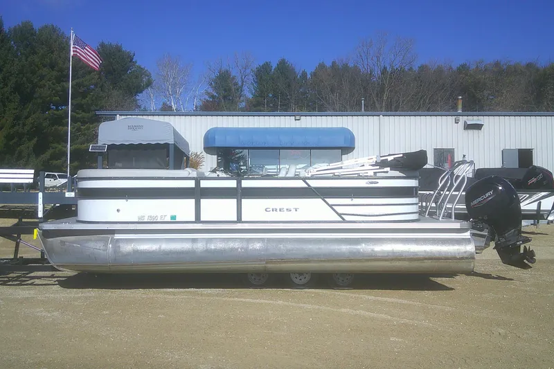 Slide: The Image of 2021 Crest Classic LX 220 SLC pontoon boat with Mercury engines, parked outdoors. - 23