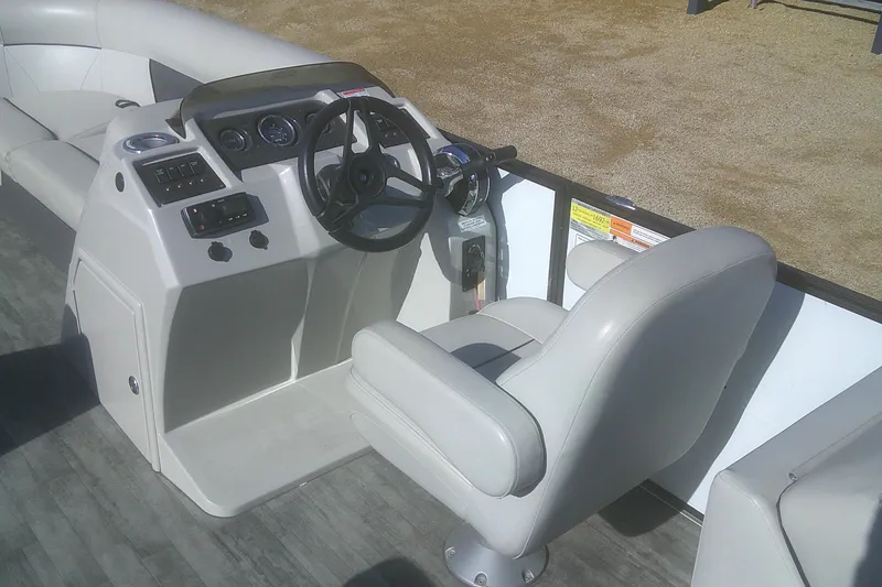 Slide: The Image of 2021 Crest Classic LX 220 SLC boat interior with steering console and seating. - 9