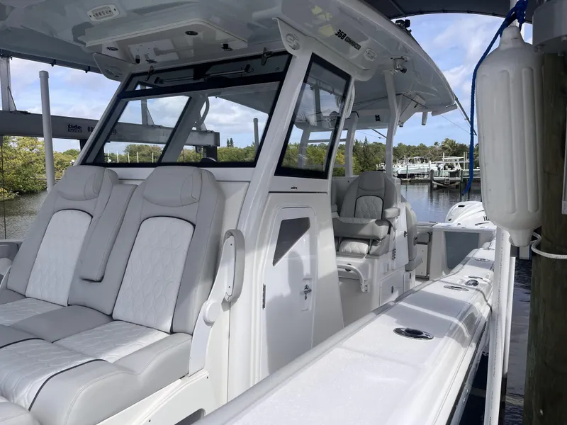 Slide: The Image of 2021 Sea Fox 368 Commander boat with luxurious seating, docked by a serene waterfront. - 28