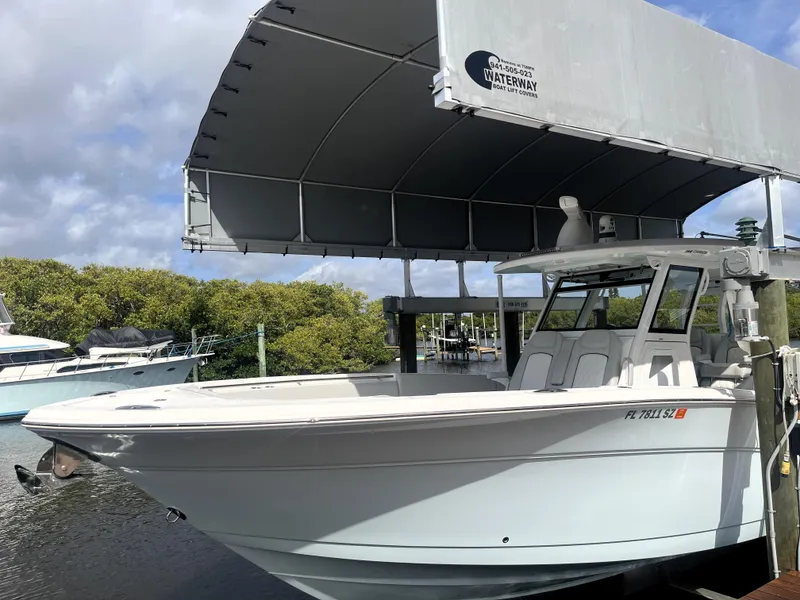 Slide: The Image of 2021 Sea Fox 368 Commander boat docked under a canopy, ready for adventure. - 6