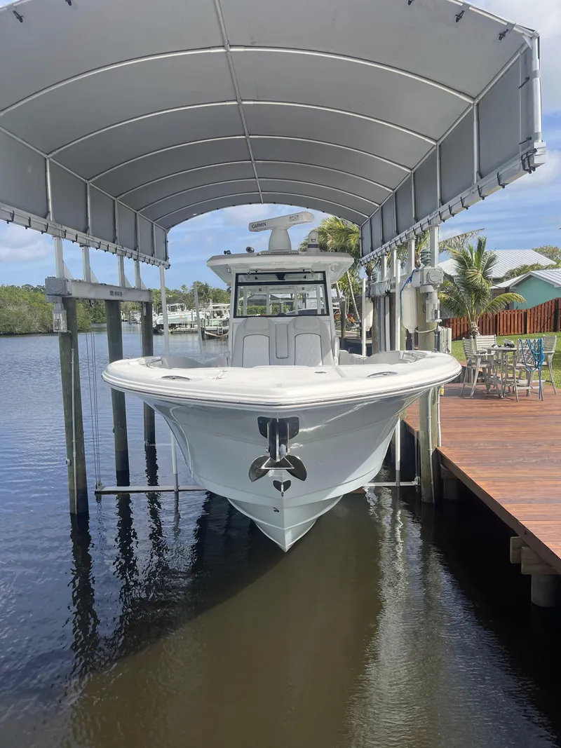 Slide: The Image of 2021 Sea Fox 368 Commander boat docked under canopy. - 8