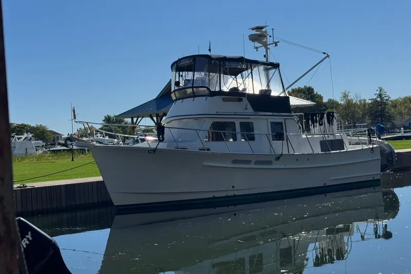 Slide: The Image of 2001 Monk Trawler boat docked in a serene marina setting. - 1