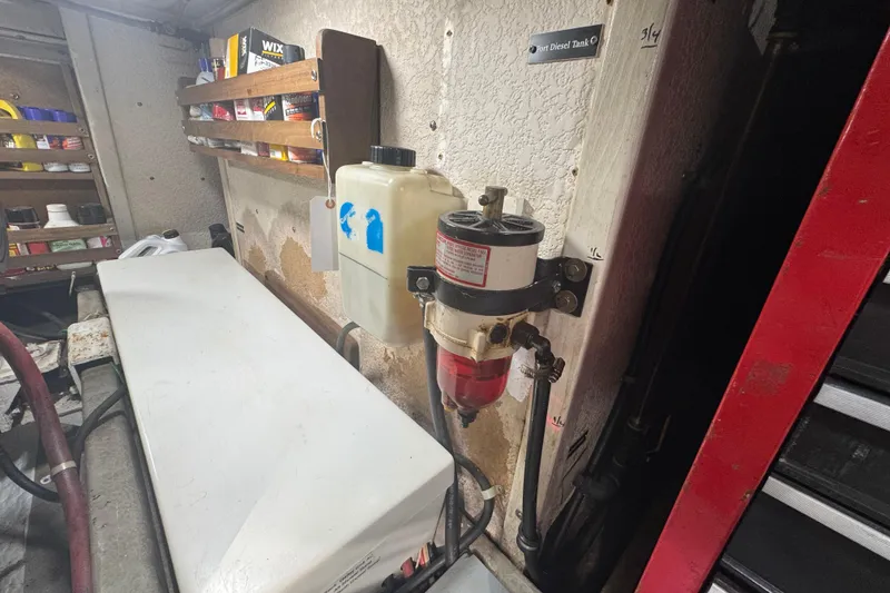 Slide: The Image of Engine room of a 2001 Monk Trawler with fuel filter and storage shelves. - 101