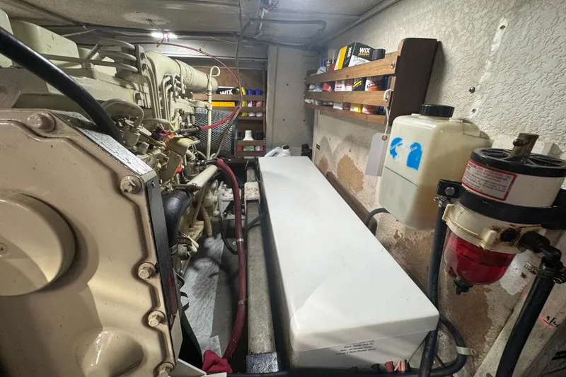 Slide: The Image of Engine room of a 2001 Monk Trawler with visible components and storage shelves. - 104