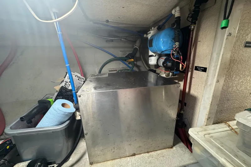 Slide: The Image of Engine room of a 2001 Monk Trawler with equipment and storage items. - 108