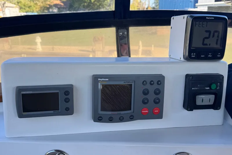 Slide: The Image of Control panel of a 2001 Monk Trawler with navigation and depth instruments. - 13