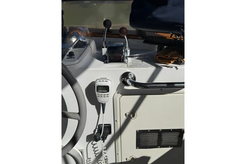 Slide: The Image of 2001 Monk Trawler helm with controls and marine radio. - 16