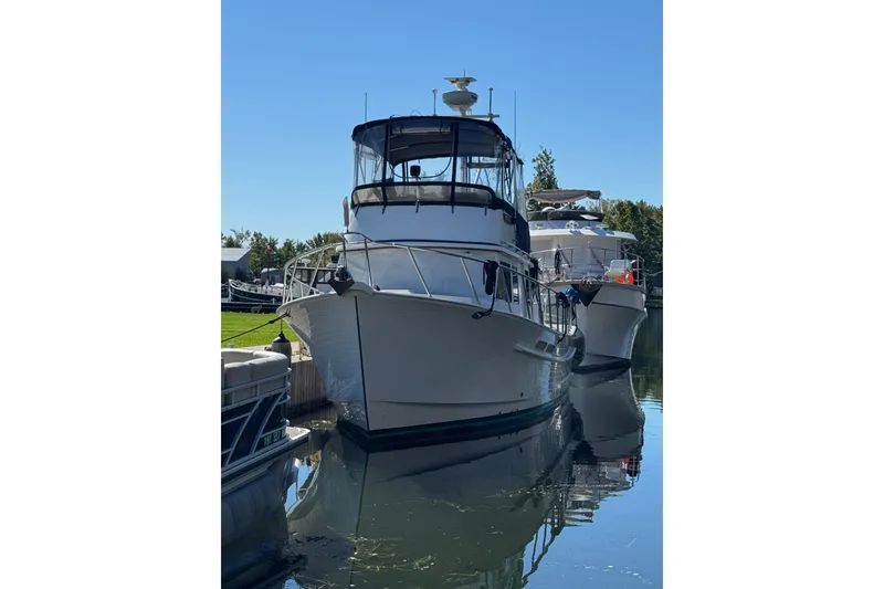 Slide: The Image of 2001 Monk Trawler docked in a serene marina setting. - 2