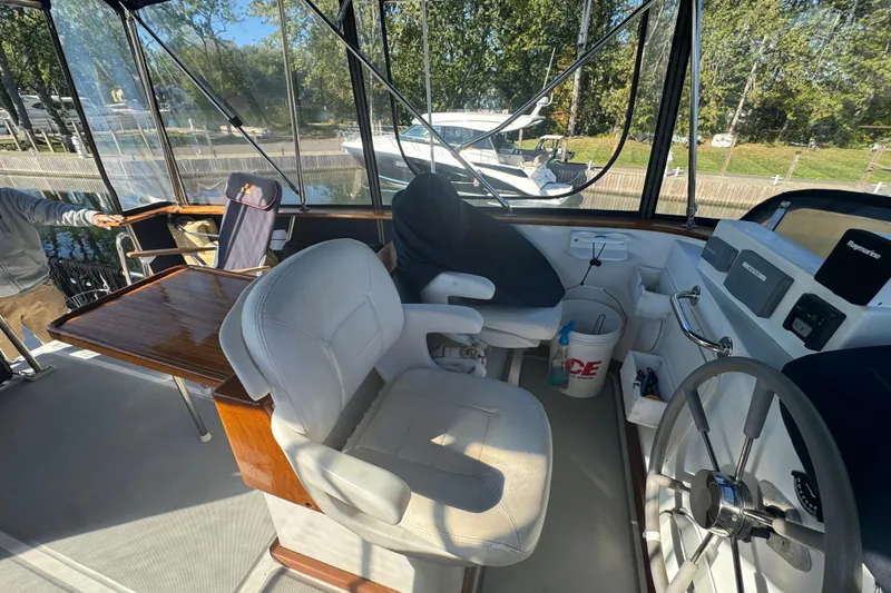 Slide: The Image of Interior of a 2001 Monk Trawler boat with helm, seating, and navigation equipment. - 20