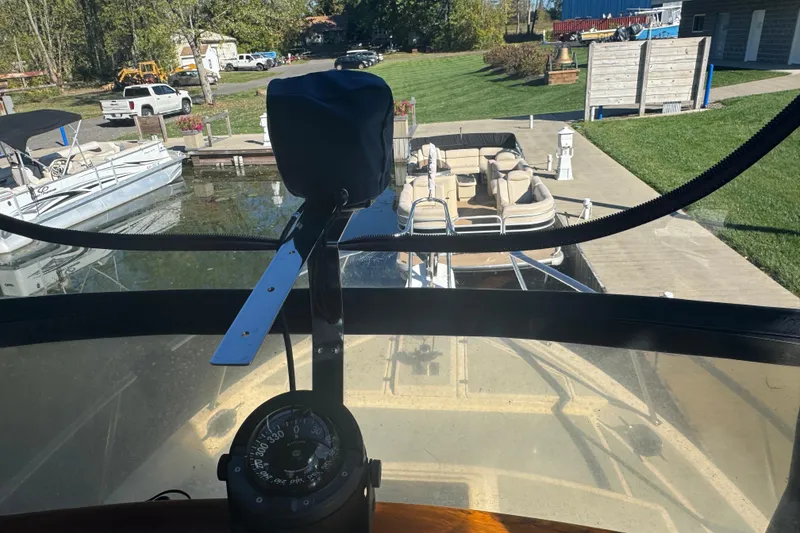 Slide: The Image of 2001 Monk Trawler view from helm, docked near other boats and green lawn. - 21