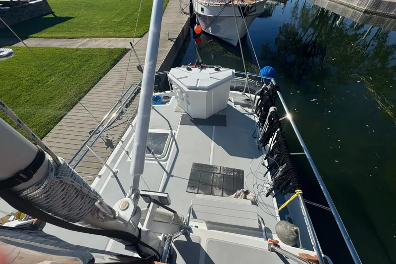 Slide: The Image of 2001 Monk Trawler docked, showcasing deck and equipment in a serene marina setting. - 23