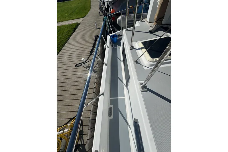 Slide: The Image of 2001 Monk Trawler deck with railing, docked beside wooden pier. - 24