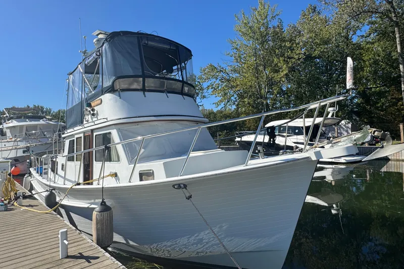 Slide: The Image of 2001 Monk Trawler docked at marina, surrounded by trees and other boats. - 3