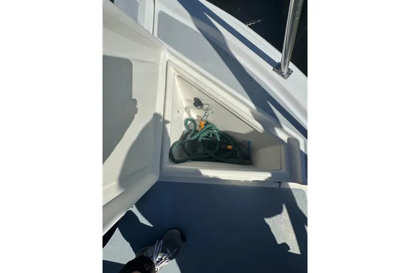 Slide: The Image of Storage compartment on 2001 Monk Trawler boat deck with rope and shadows. - 32