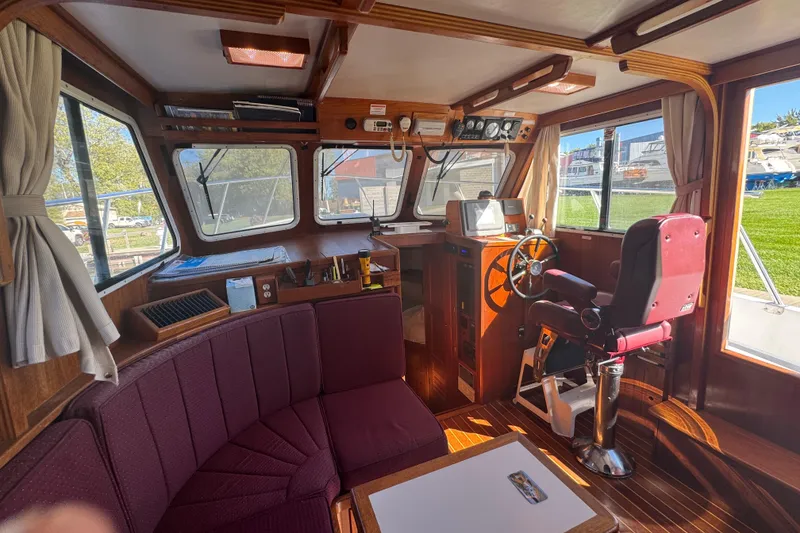 Slide: The Image of Interior of a 2001 Monk Trawler with helm, seating, and navigation equipment. - 35